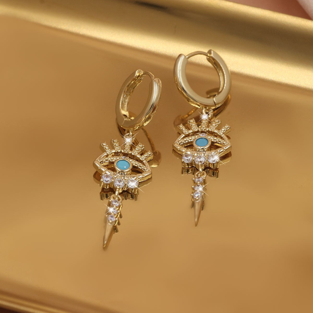 boucles d'oreilles pendantes motifs oeil